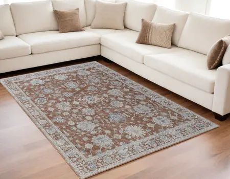 5' X 8' Red Blue and Ivory Floral Power Loom Worn Faded Area Rug With Fringe