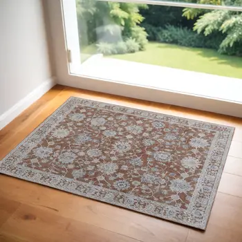 2' X 3' Red Blue and Ivory Floral Power Loom Worn Faded Area Rug With Fringe