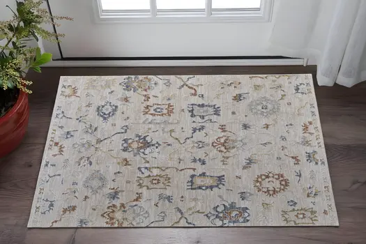 2' X 3' Ivory Blue and Gold Floral Power Loom Worn Faded Area Rug With Fringe