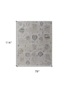 7' X 10' Ivory Taupe and Blue Floral Power Loom Worn Faded Area Rug With Fringe