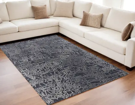 5' X 8' Black Gray and Ivory Abstract Hand Woven Area Rug