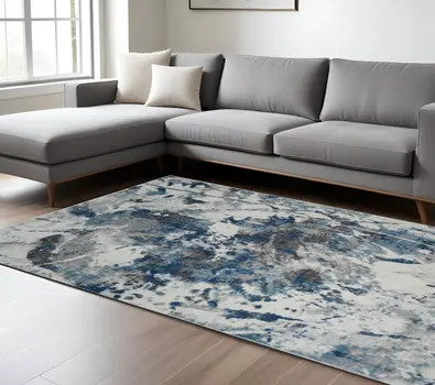 7' X 9' Ivory Teal And Black Abstract Area Rug