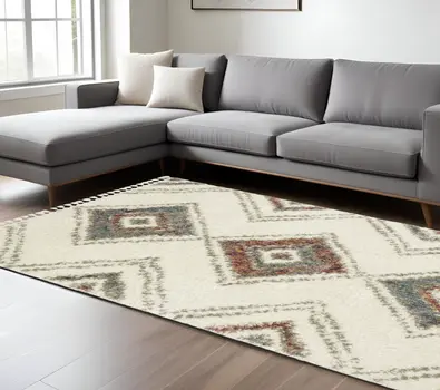 10' X 13' Ivory Red And Orange Southwestern Shag Area Rug With Fringe