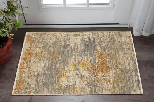 2' X 3' Beige And Gold Abstract Area Rug With Fringe