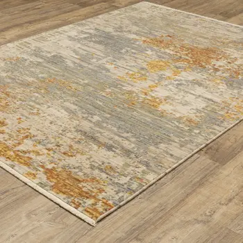 5' X 8' Beige And Gold Abstract Area Rug With Fringe