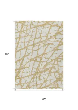 5' X 8' Gold And Ivory Abstract Washable Indoor Outdoor Area Rug