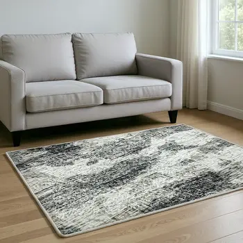 5' X 8' Black And Ivory Abstract Washable Area Rug With UV Protection
