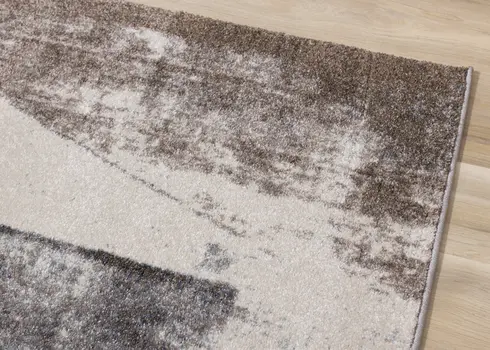 5' X 8' Cream And Brown Geometric Area Rug