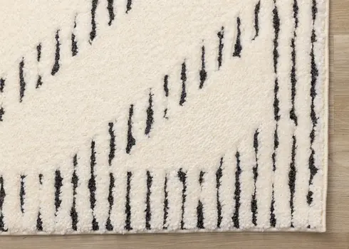 5' X 8' Cream And Black Geometric Area Rug
