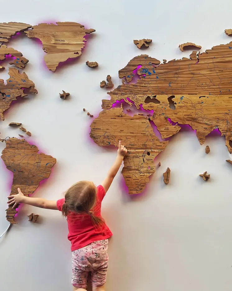World map illuminated from solid oak