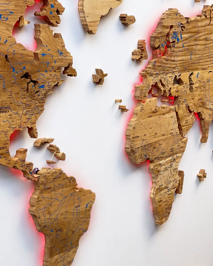World map illuminated from solid oak