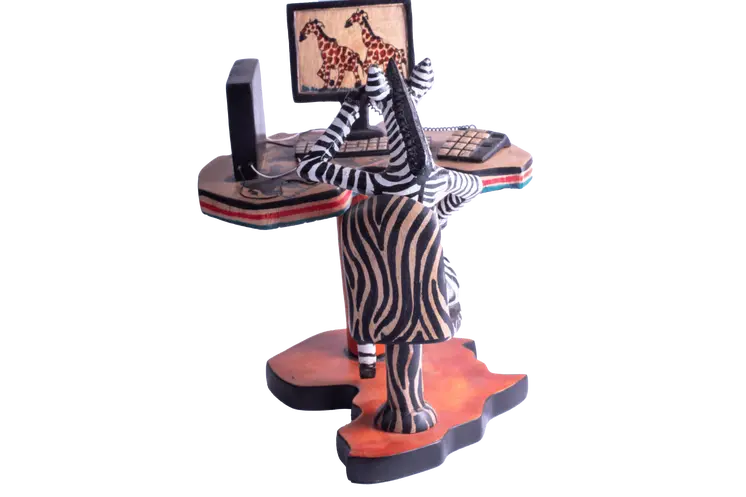 Wooden Zebra Sitting at Computer