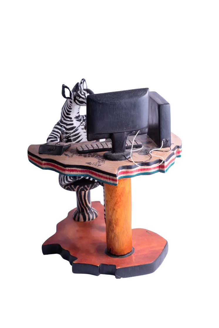 Wooden Zebra Sitting at Computer