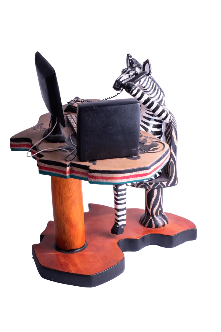 Wooden Zebra Sitting at Computer