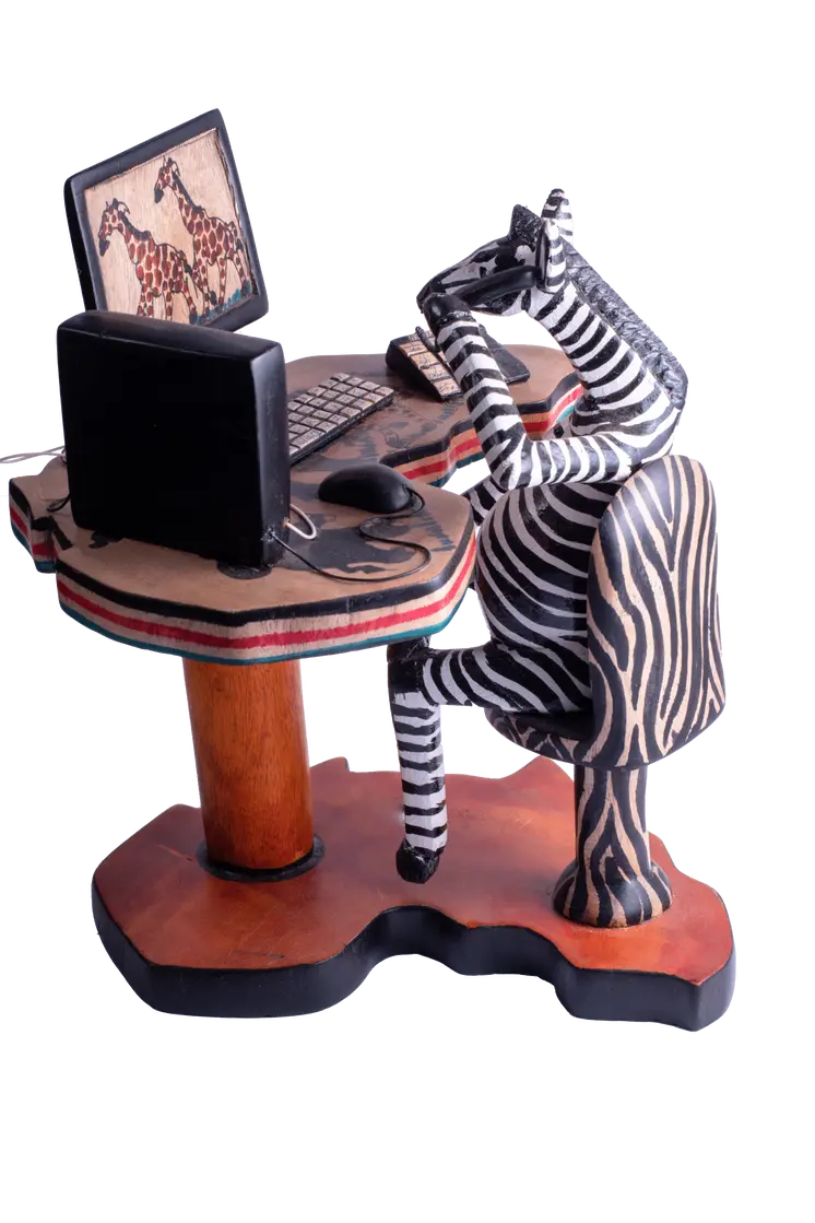 Wooden Zebra Sitting at Computer