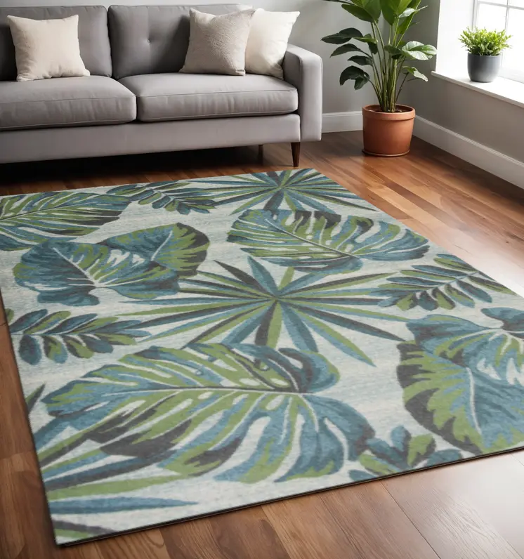 5' X 8' Beige Teal and Green Tropical Botanical Leaves Area Rug