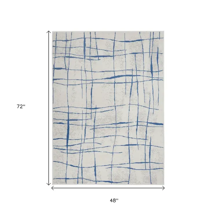 4' X 6' Ivory And Blue Geometric Distressed Area Rug