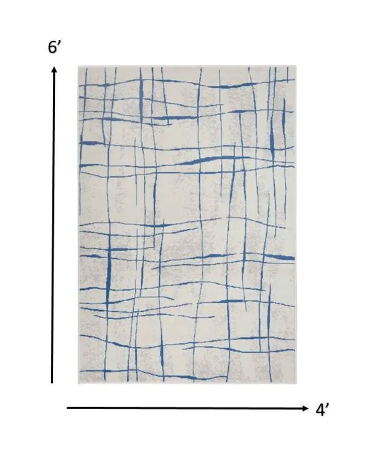 4' X 6' Ivory And Blue Geometric Distressed Area Rug