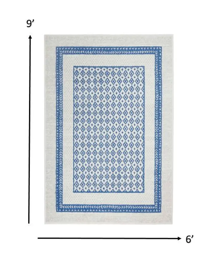6' X 9' Ivory And Blue Geometric Area Rug