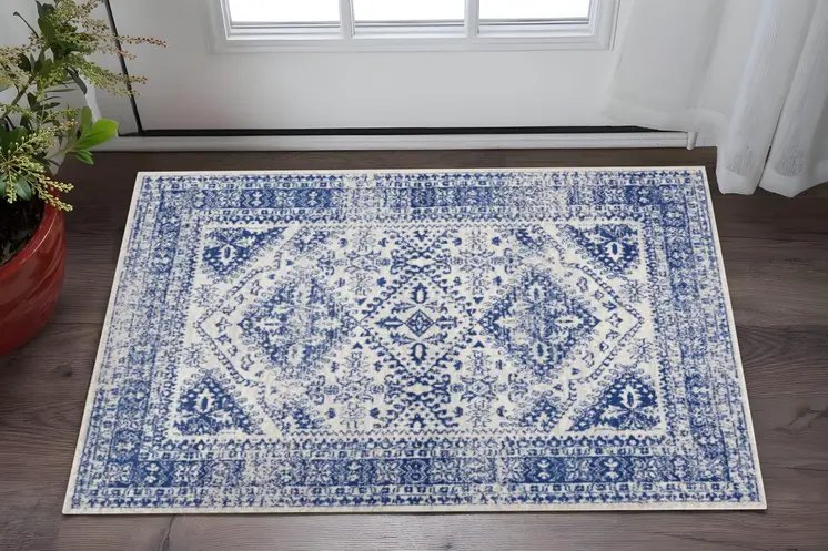 6' X 9' Ivory And Blue Geometric Distressed Area Rug