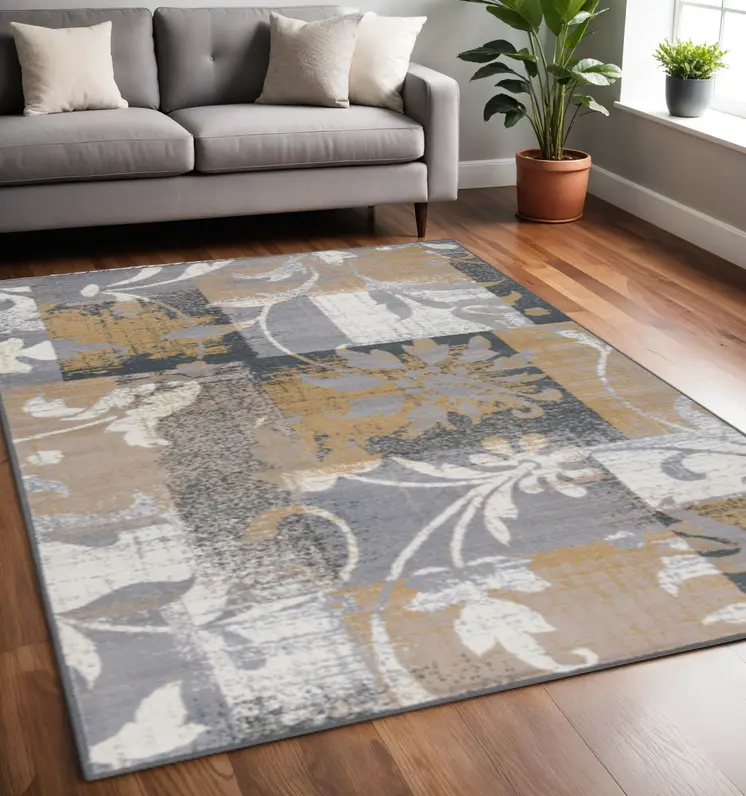 5' X 8' Beige And Gray Floral Power Loom Distressed Stain Resistant Area Rug