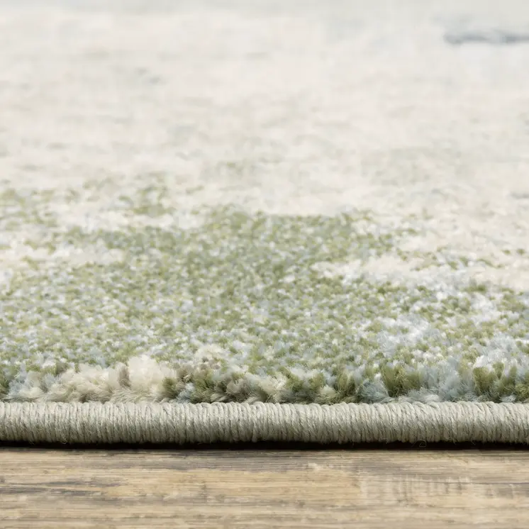 7' X 9' Green And Ivory Abstract Area Rug