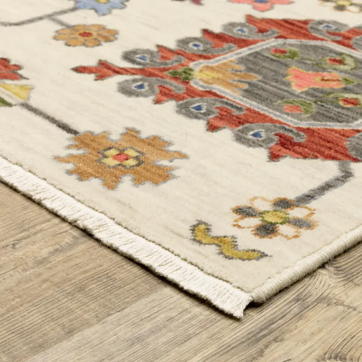 6' X 9' Ivory Yellow Rust Green Grey Pink Orange Blue And Grey Oriental Power Loom Stain Resistant Area Rug With Fringe