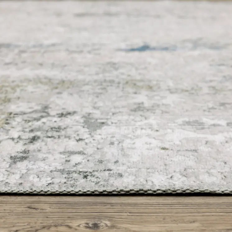 5' X 7' Ivory Teal Blue Grey Brown And Gold Abstract Printed Stain Resistant Non Skid Area Rug