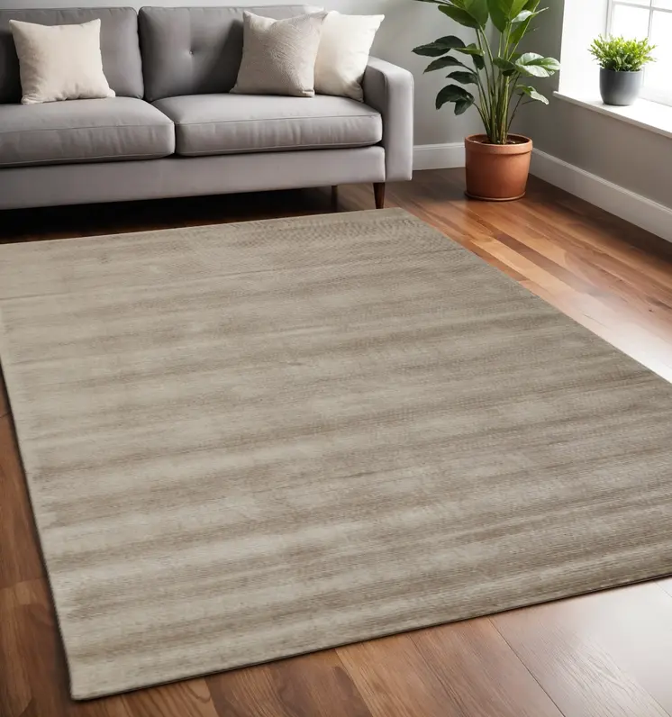 5' X 8' Tan Ivory And Taupe Hand Woven Area Rug