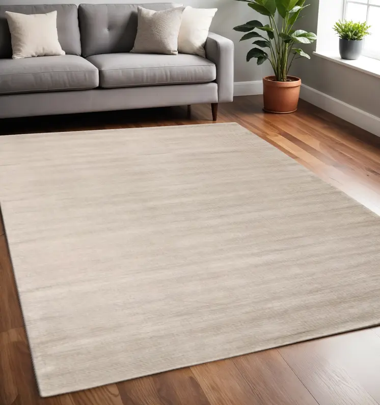 5' X 8' Ivory And Taupe Hand Woven Distressed Area Rug