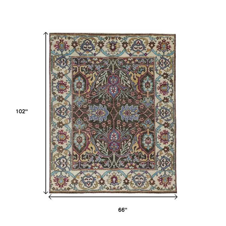 5' X 8' Ivory Brown And Blue Wool Floral Hand Knotted Distressed Stain Resistant Area Rug With Fringe