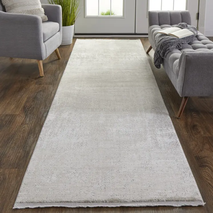 10' Tan and Ivory Abstract Power Loom Distressed Runner Rug With Fringe