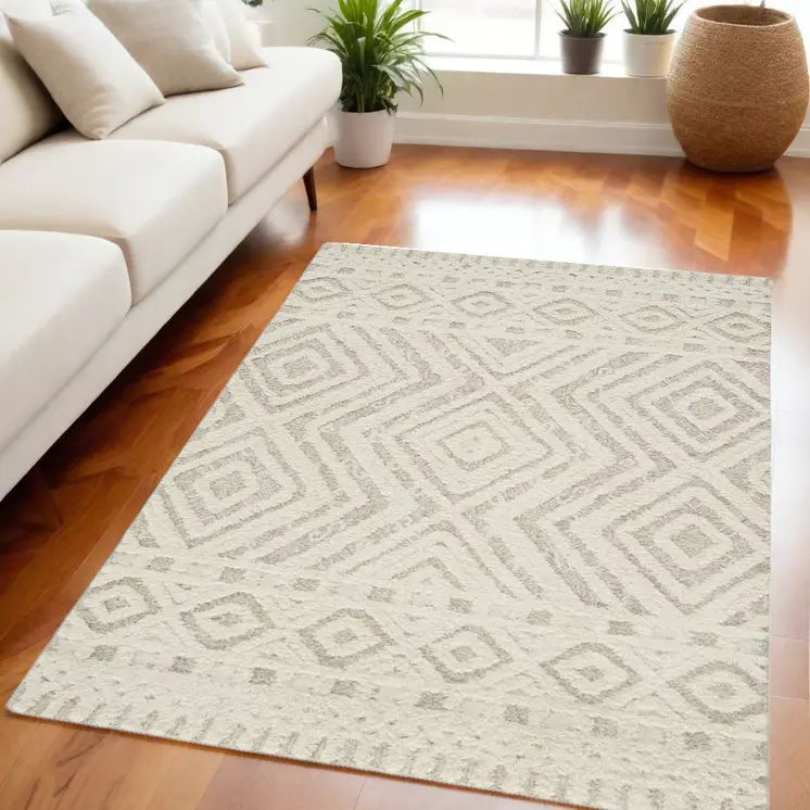 5' X 8' Ivory And Tan Wool Geometric Tufted Handmade Stain Resistant Area Rug
