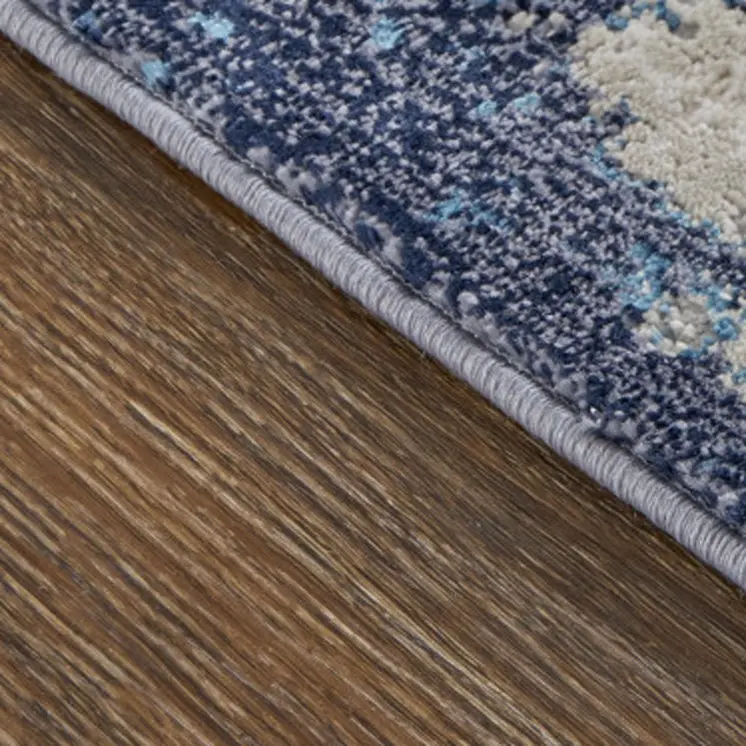 7' X 10' Tan Blue And Ivory Abstract Power Loom Distressed Area Rug