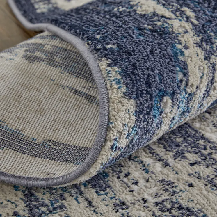 10' X 13' Tan Blue And Ivory Abstract Power Loom Distressed Area Rug