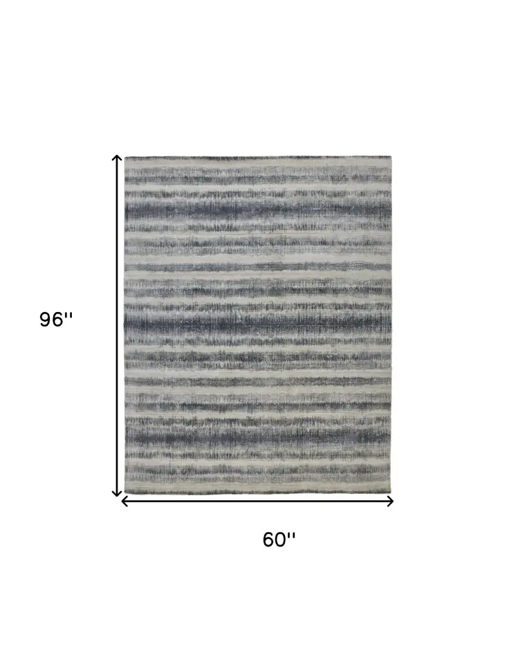 5' X 8' Ivory And Blue Abstract Hand Woven Area Rug
