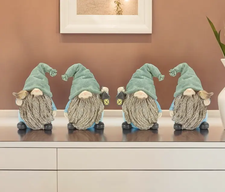 Set of Four Blue and Green Polyresin Christmas Figurine Tabletop Sculpture
