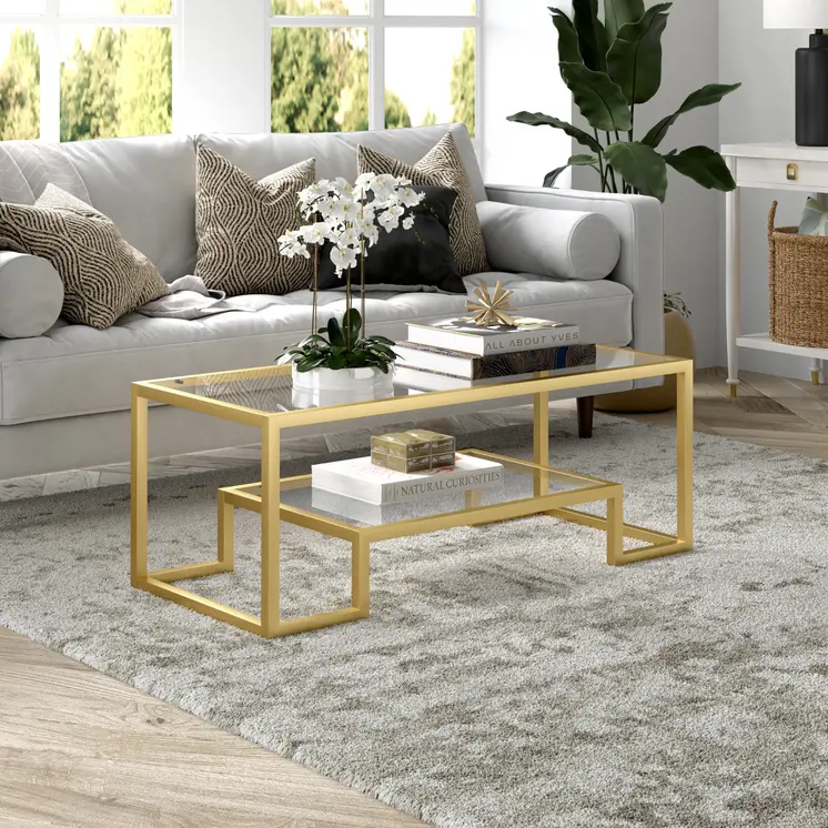 45" Clear And Gold Glass And Steel Sled Coffee Table With Shelf