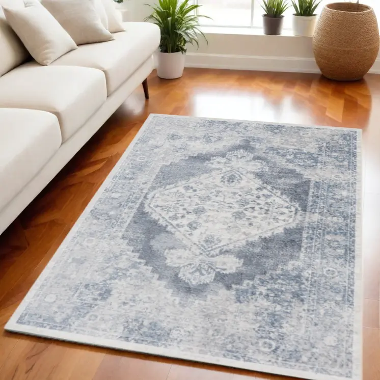 5' X 7' Blue and Ivory Abstract Power Loom Washable Area Rug