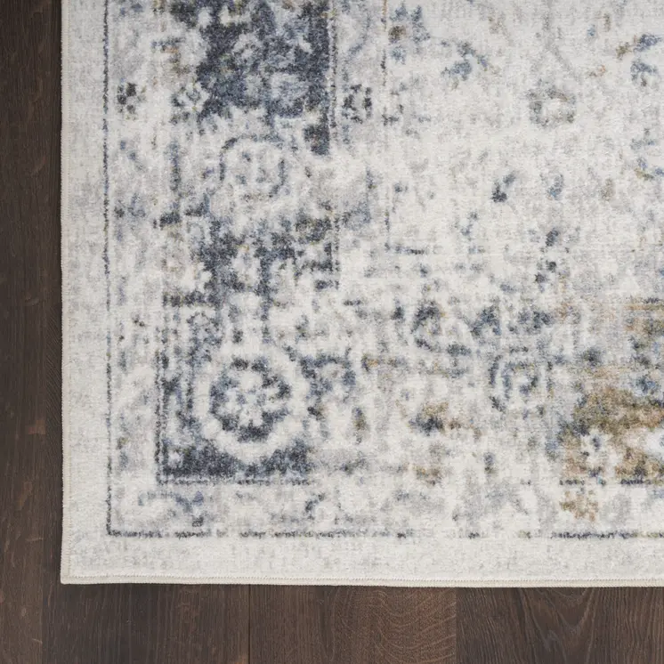 7' X 9' Blue and Ivory Floral Medallion Power Loom Distressed Washable Area Rug