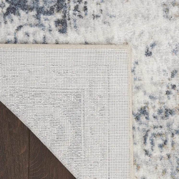 7' X 9' Blue and Ivory Floral Medallion Power Loom Distressed Washable Area Rug