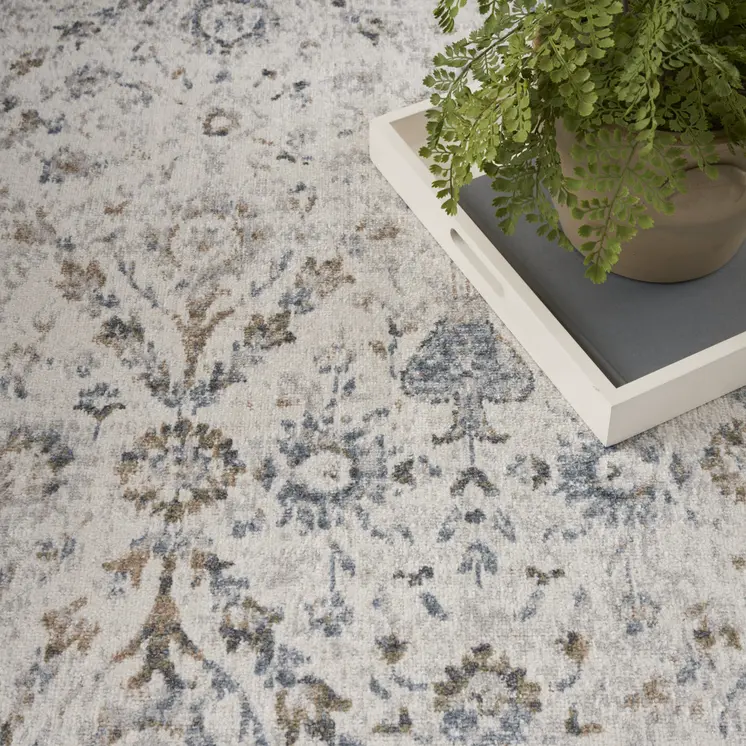 7' X 9' Blue and Ivory Floral Medallion Power Loom Distressed Washable Area Rug