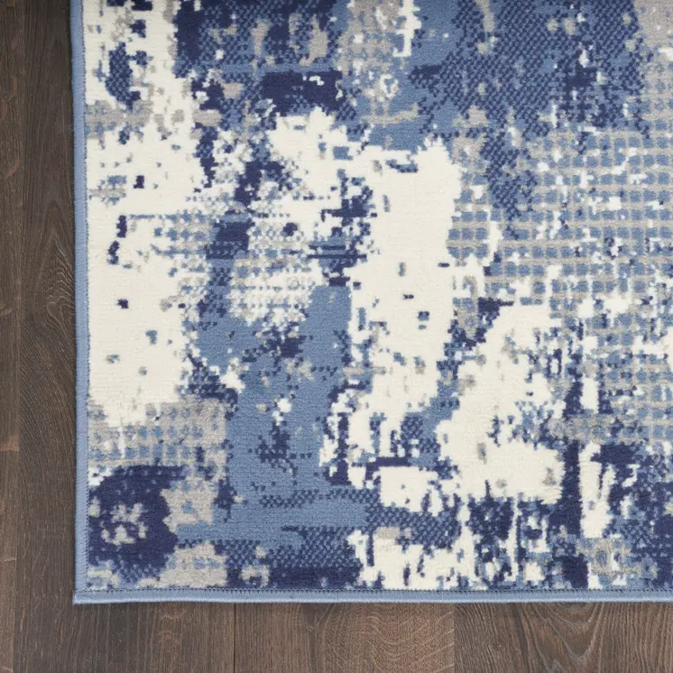 5' X 7' Blue and Ivory Abstract Power Loom Area Rug
