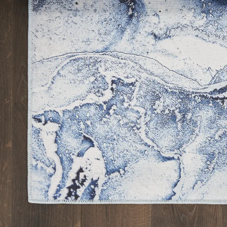 5' X 7' Ivory and Blue Abstract Power Loom Area Rug