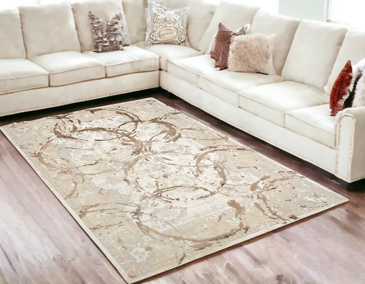 5' X 8' Beige and Gold Abstract Area Rug