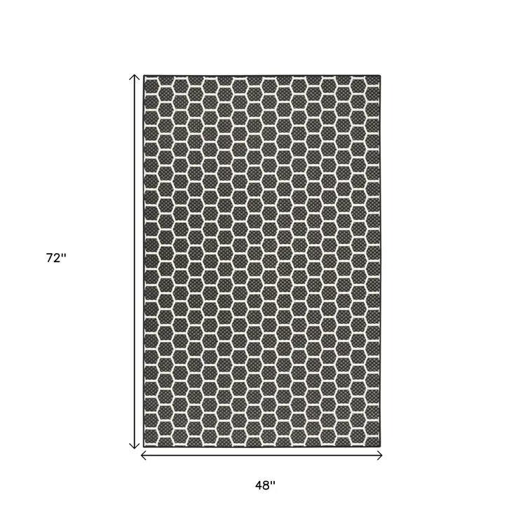 5' X 7' Black And Ivory Geometric Indoor Outdoor Area Rug