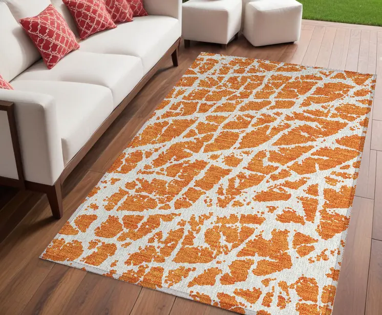 5' X 8' Orange and White Abstract Washable Non Skid Indoor Outdoor Area Rug