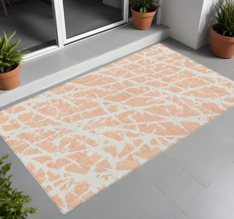 2' X 3' Peach and Ivory Abstract Washable Non Skid Indoor Outdoor Area Rug