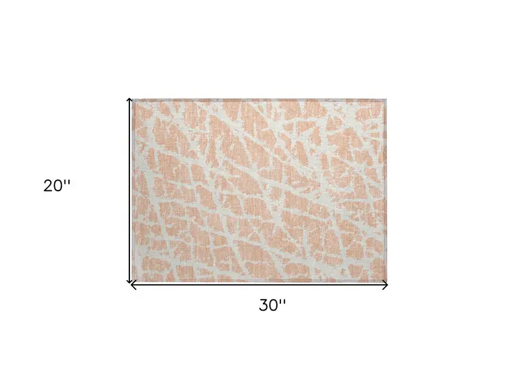 2' X 3' Peach and Ivory Abstract Washable Non Skid Indoor Outdoor Area Rug