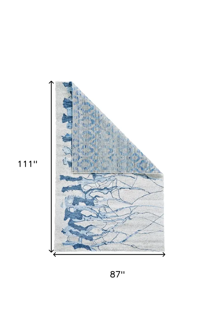 7' X 9' Blue and Ivory Abstract Hand Tufted Area Rug